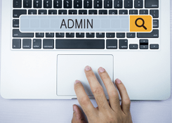 Admin hand on laptop keyboard